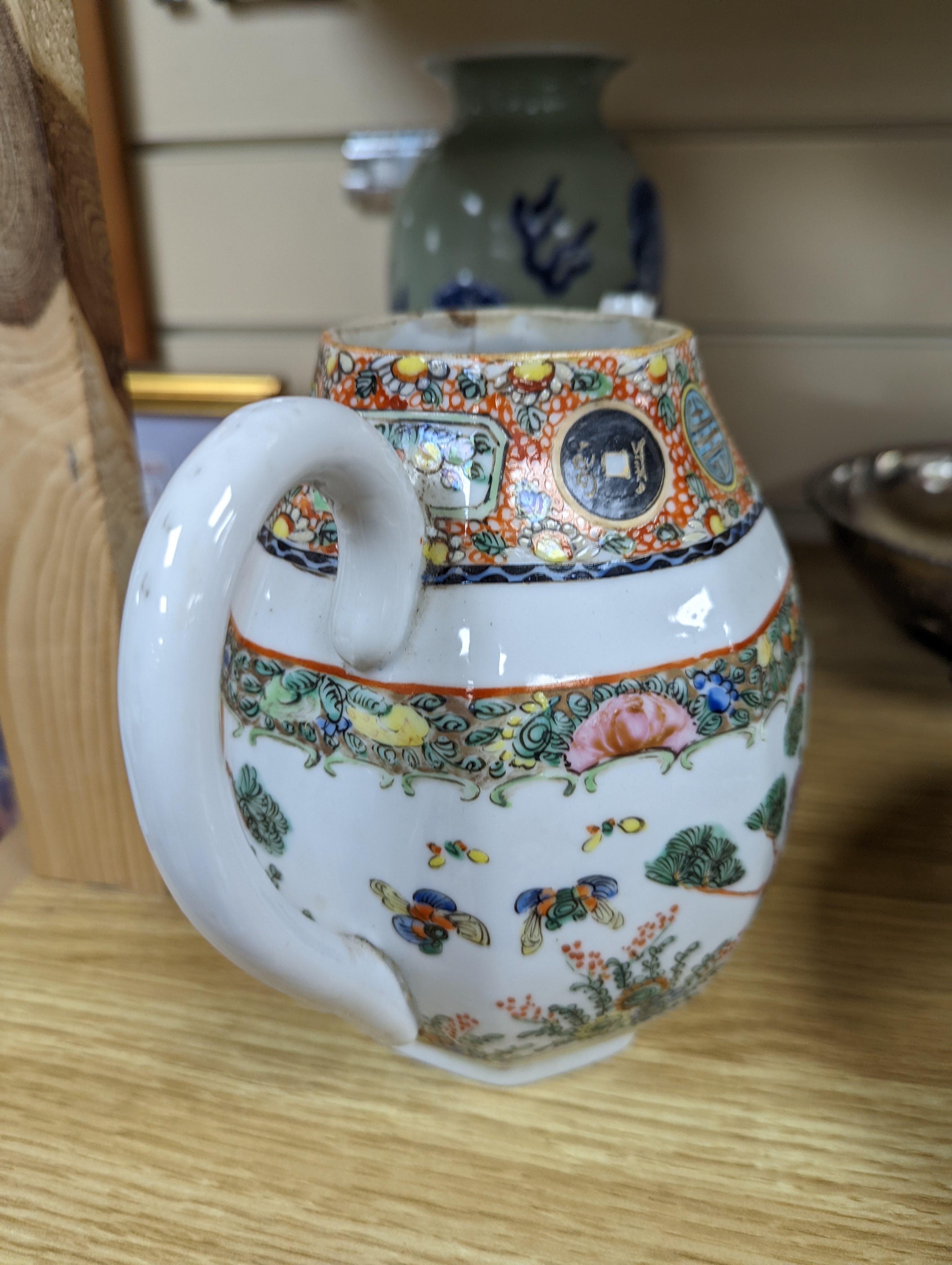 A Chinese celadon glazed vase, 24cm and a Chinese famille rose teapot and matching cream jug, a.f.